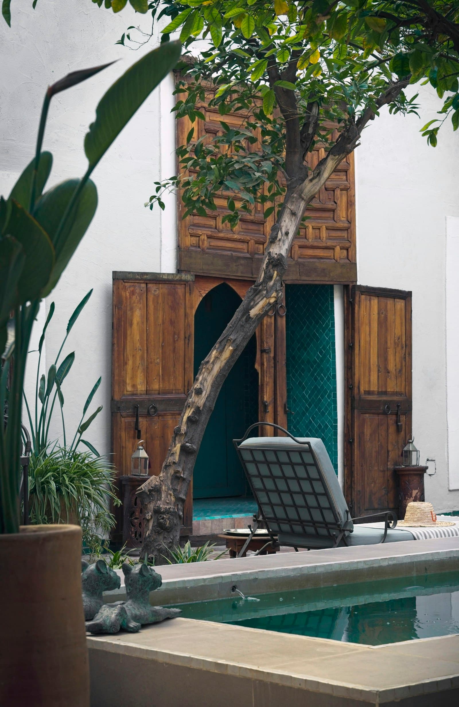 Marrakech riad courtyard with pool and traditional wooden door